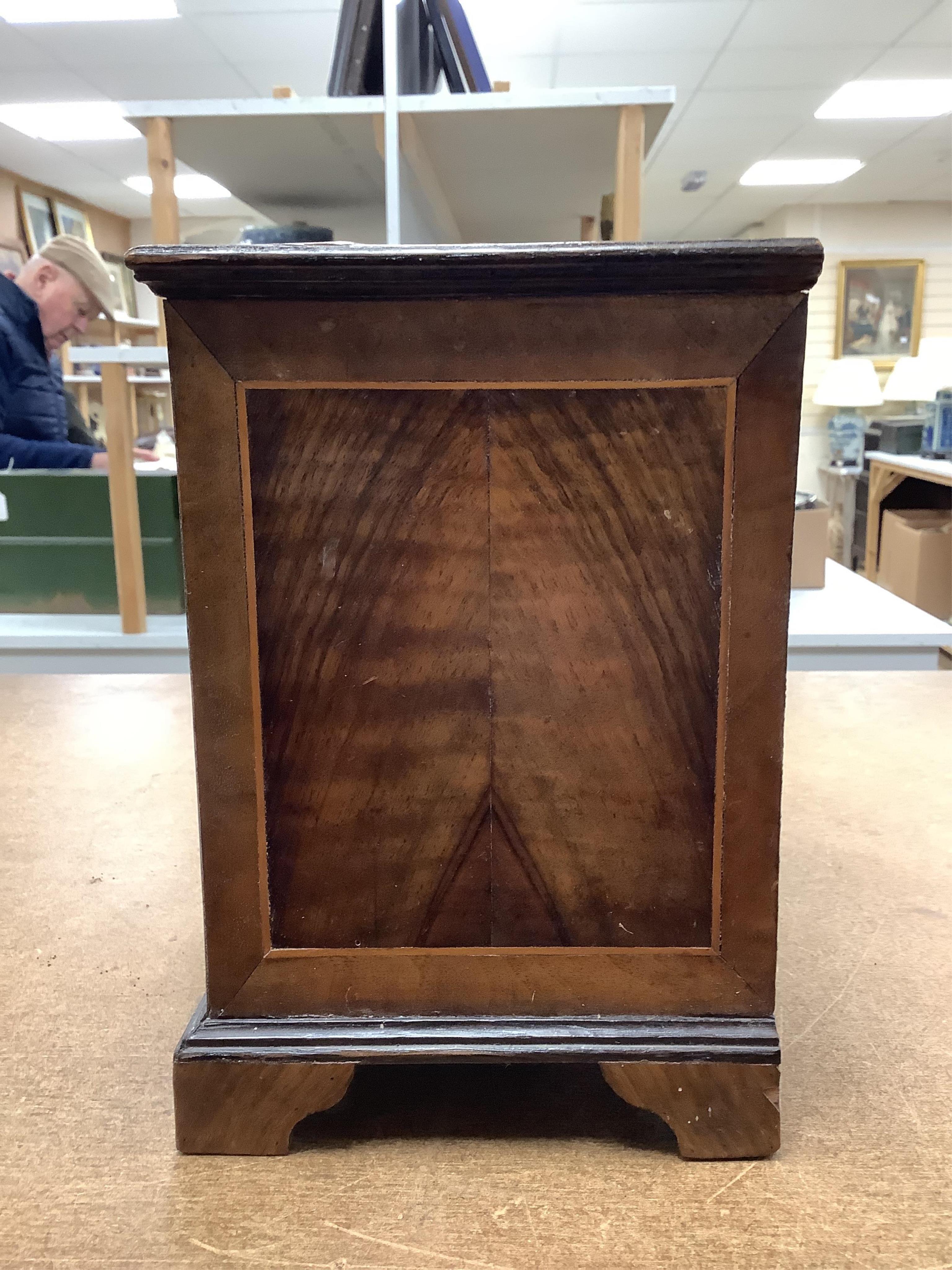 A miniature three long and two short inlaid chest of drawers, 21.5cm high x 23.5cm wide. Condition - poor to fair